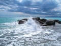Sea Ã¢â¬â¹Ã¢â¬â¹coast with rocks after a storm, black clouds in the sky. Royalty Free Stock Photo